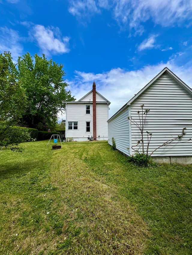 back of house featuring a yard