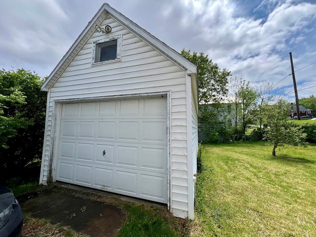 garage featuring a lawn