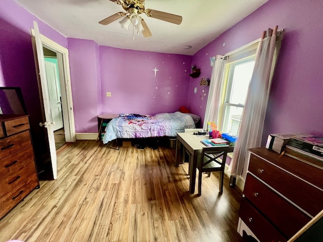 bedroom with ceiling fan and light hardwood / wood-style floors