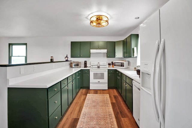 667 Ostrom Hill Rd, Liberty, PA 16930 - kitchen with green cabinets, white appliances, under cabinet range hood, and wood finished floors