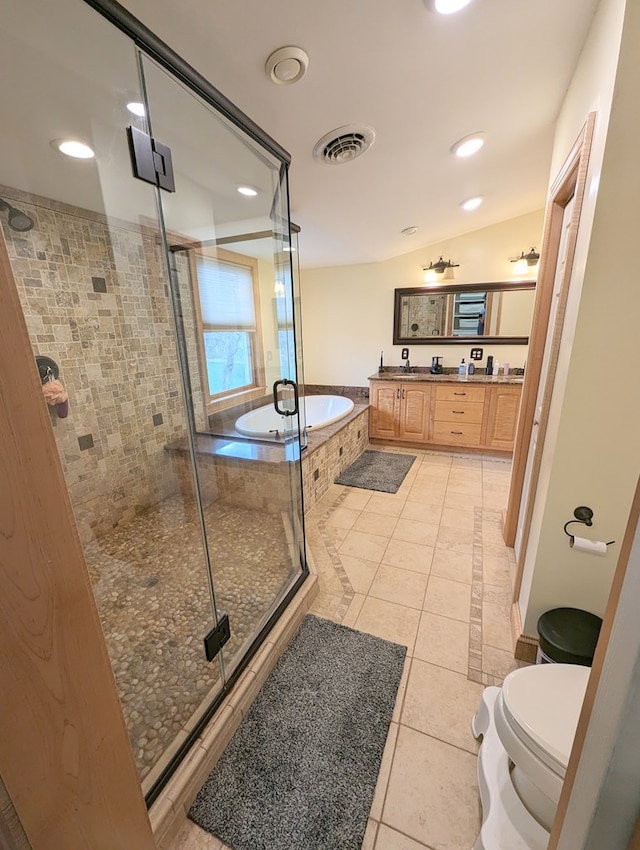 full bathroom featuring tile patterned floors, vaulted ceiling, toilet, vanity, and shower with separate bathtub