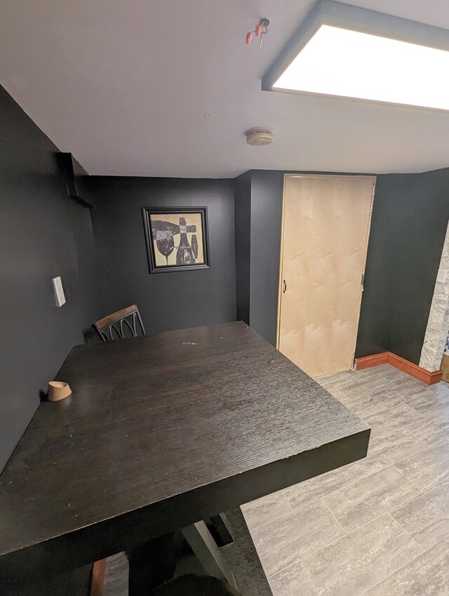 dining space with wood-type flooring