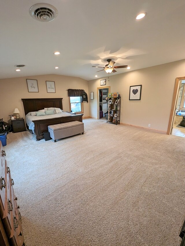 carpeted bedroom featuring ceiling fan and lofted ceiling