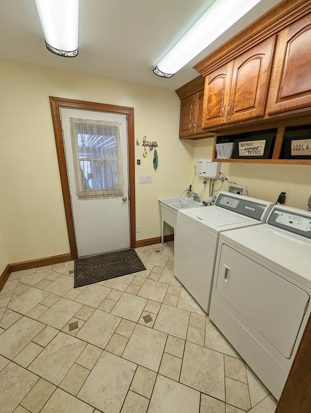 washroom featuring cabinets, sink, and washing machine and clothes dryer