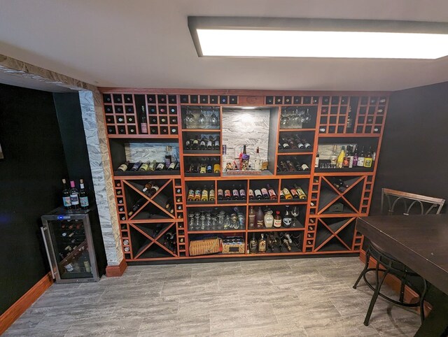 wine room featuring hardwood / wood-style flooring and wine cooler