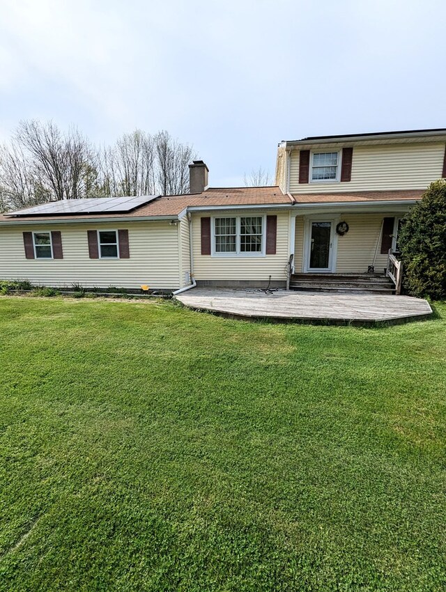 back of house with a patio area and a yard