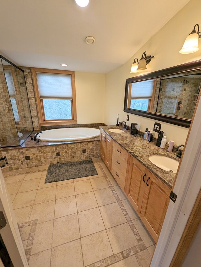 bathroom with tile patterned flooring, vanity, and independent shower and bath