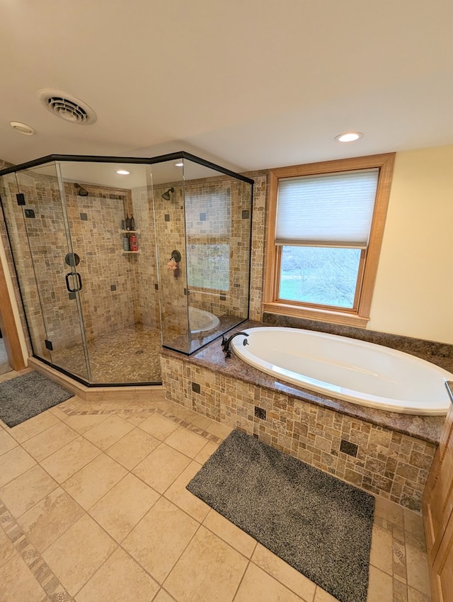 bathroom featuring tile patterned floors and shower with separate bathtub