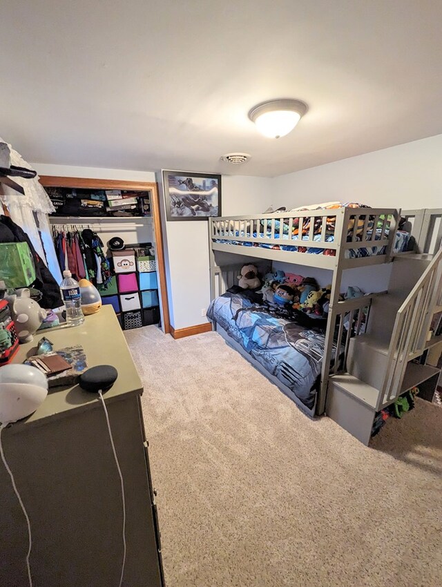 bedroom with light carpet and a closet