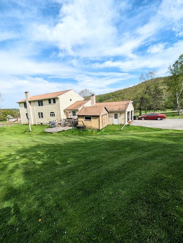 back of property featuring a yard