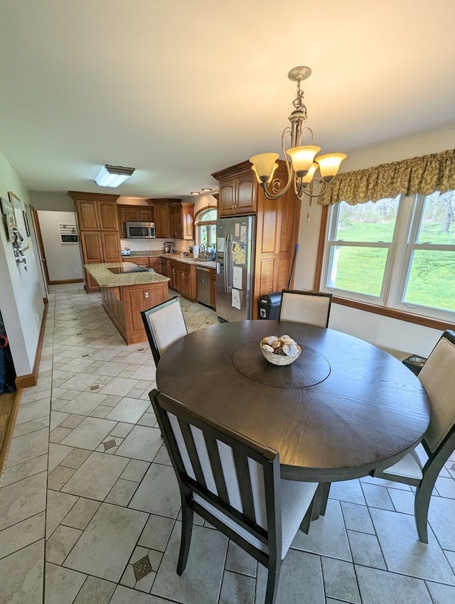 dining area with an inviting chandelier