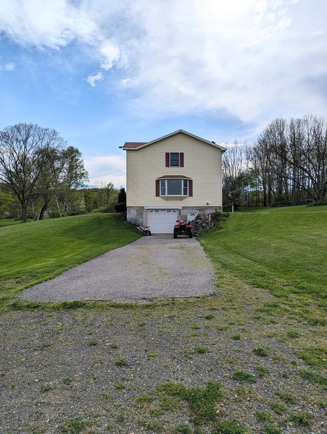 view of home's exterior featuring a lawn and a garage