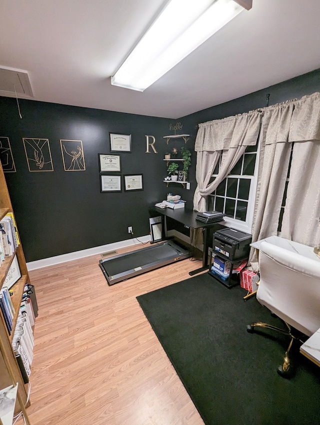 exercise room with hardwood / wood-style flooring