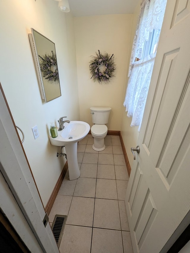 bathroom featuring tile patterned flooring and toilet