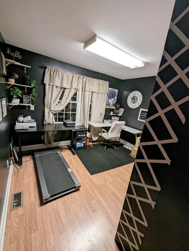 exercise room with hardwood / wood-style flooring