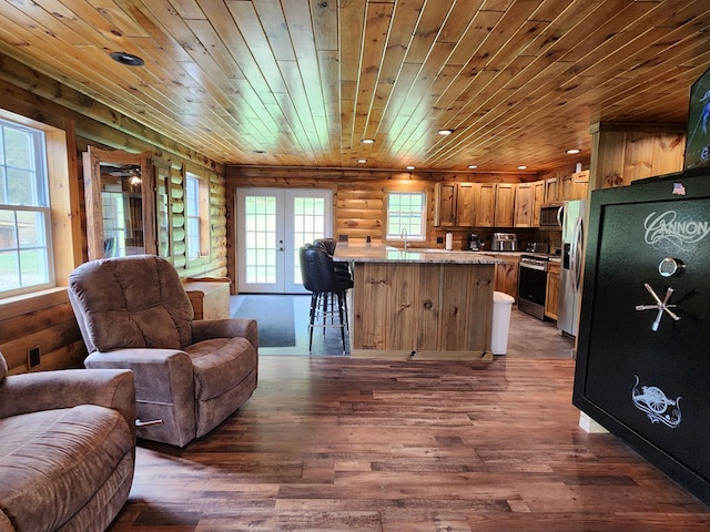 kitchen featuring appliances with stainless steel finishes, dark hardwood / wood-style flooring, french doors, rustic walls, and wooden ceiling