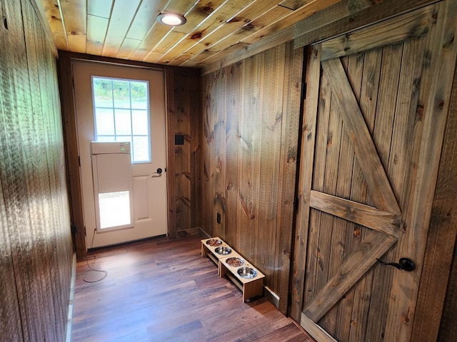 entryway featuring hardwood / wood-style floors, wooden walls, and wooden ceiling