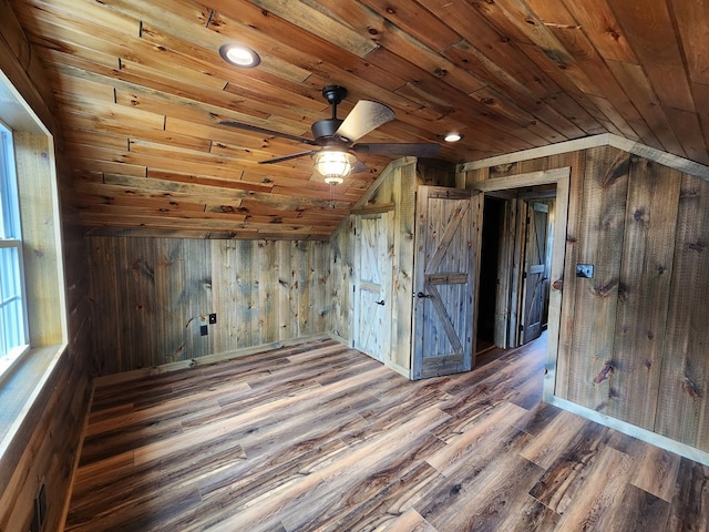 additional living space with wood walls, wood ceiling, and vaulted ceiling