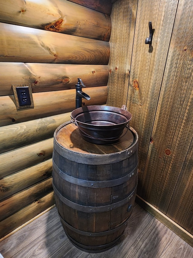 details featuring hardwood / wood-style floors and log walls