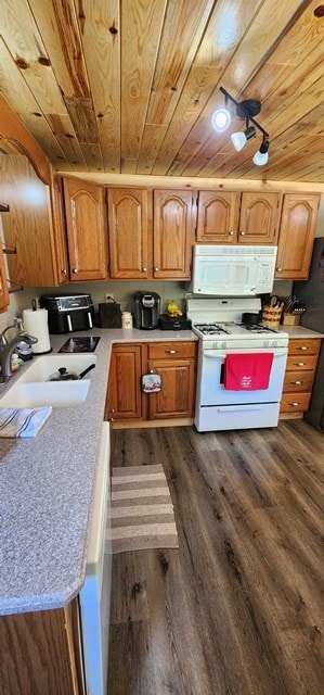 kitchen with white appliances, dark wood-type flooring, wooden ceiling, and sink