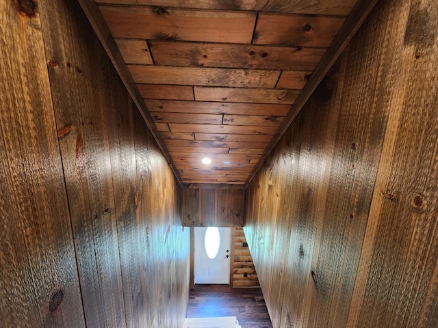 hallway featuring wood walls and wood ceiling