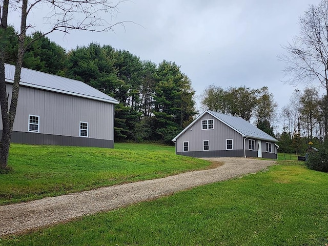 view of side of property with a yard