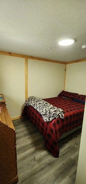 bedroom featuring wood-type flooring and ornamental molding