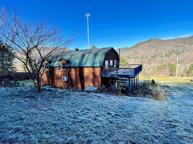 view of side of property featuring a deck with mountain view