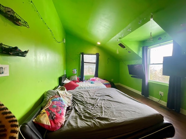 bedroom featuring lofted ceiling and hardwood / wood-style floors