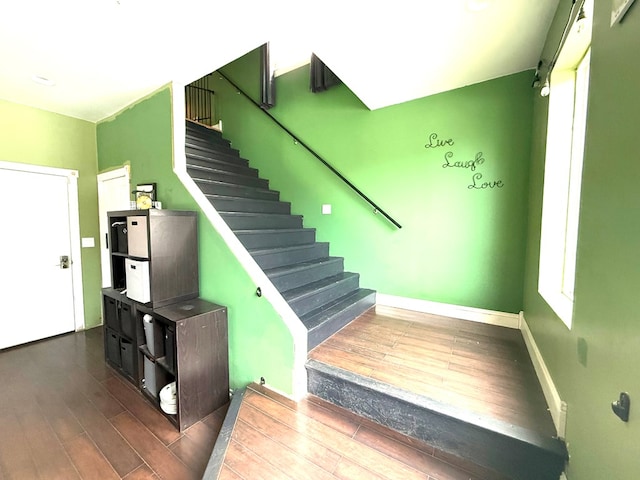 stairs featuring wood-type flooring