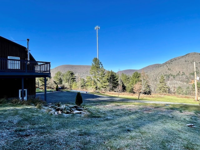 view of yard featuring a deck with mountain view