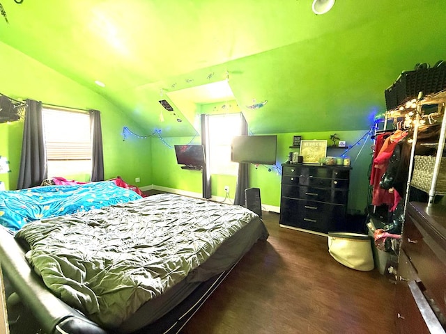 bedroom with vaulted ceiling and dark hardwood / wood-style floors