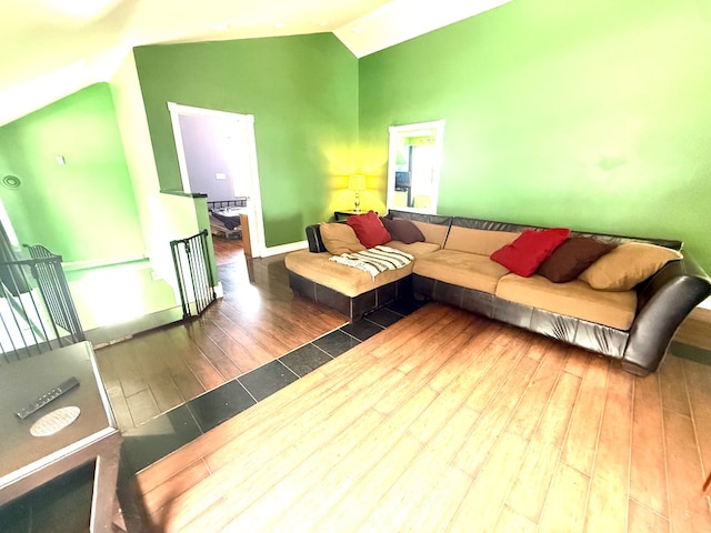 living room with hardwood / wood-style flooring and vaulted ceiling