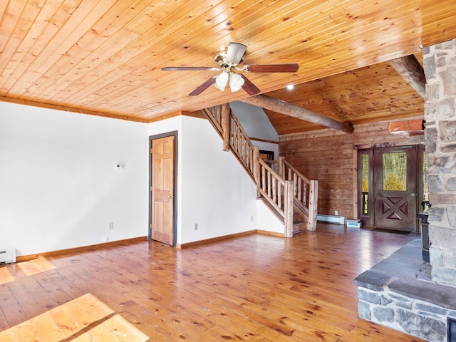 unfurnished living room with baseboard heating, wooden ceiling, stairs, and hardwood / wood-style floors