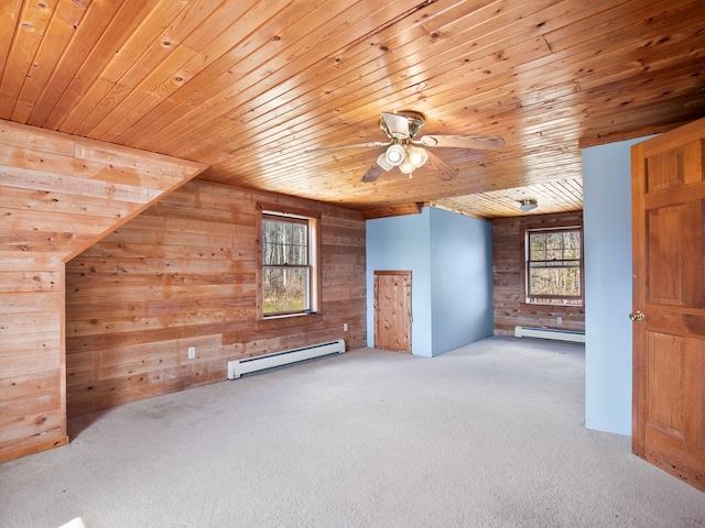 bonus room featuring a baseboard heating unit, wooden walls, wood ceiling, and carpet floors