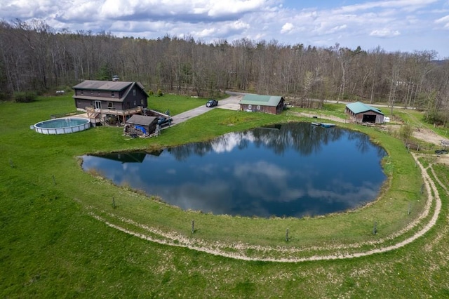 bird's eye view featuring a wooded view and a water view