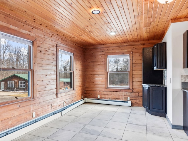 interior space with a baseboard heating unit, wooden ceiling, and a wealth of natural light