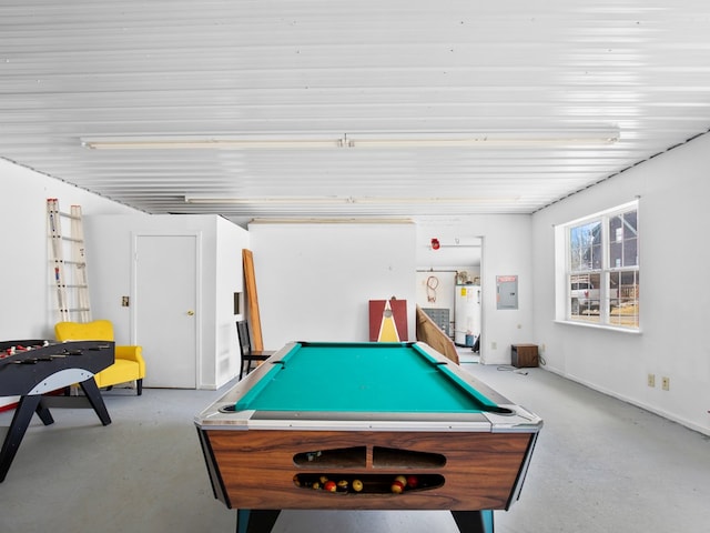 playroom with water heater, pool table, concrete flooring, and electric panel