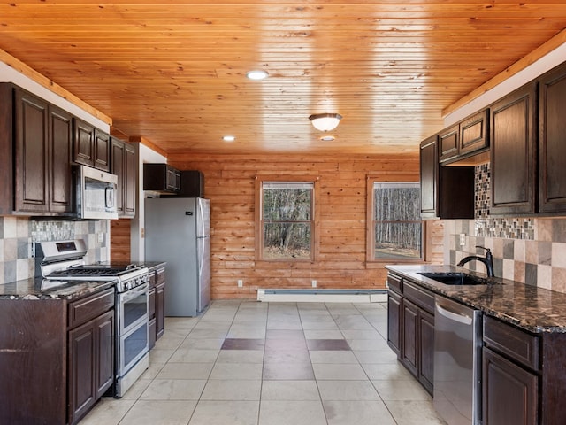 kitchen with a sink, stainless steel appliances, and dark brown cabinets