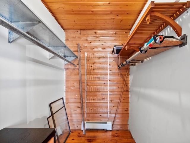 spacious closet with baseboard heating and wood finished floors