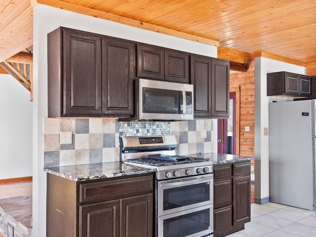 kitchen featuring dark brown cabinets, tasteful backsplash, appliances with stainless steel finishes, and light tile patterned floors