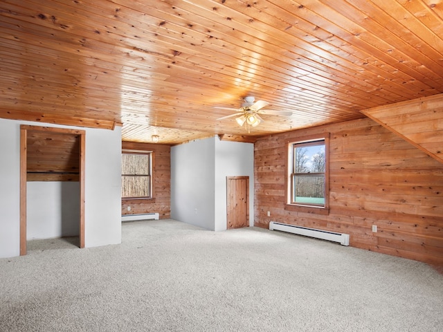 additional living space featuring wooden ceiling, carpet flooring, baseboard heating, and a baseboard radiator