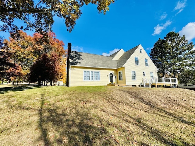 view of front facade featuring a deck and a front yard