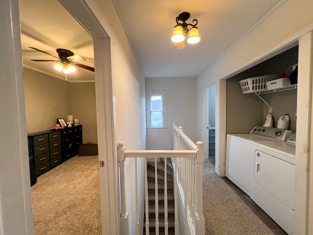 clothes washing area featuring crown molding, independent washer and dryer, a chandelier, and carpet