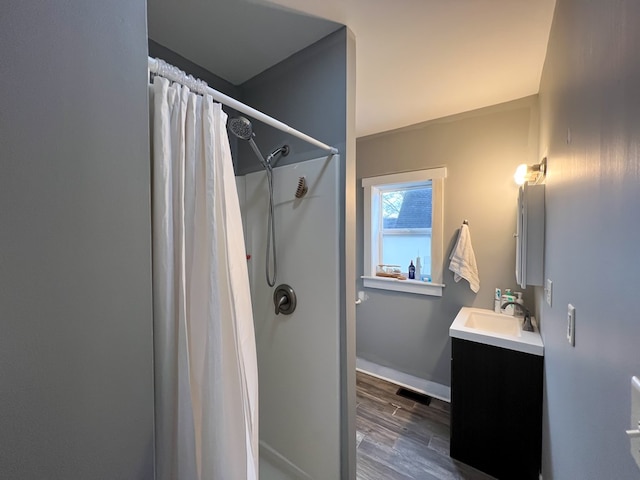 bathroom with hardwood / wood-style flooring, vanity, and a shower with curtain