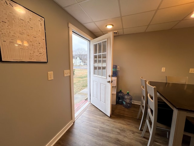 entryway featuring hardwood / wood-style floors and a drop ceiling