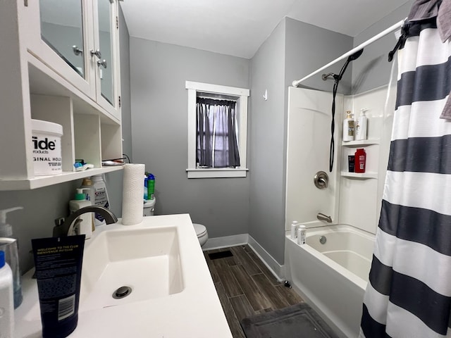 full bathroom with vanity, shower / tub combo, and toilet