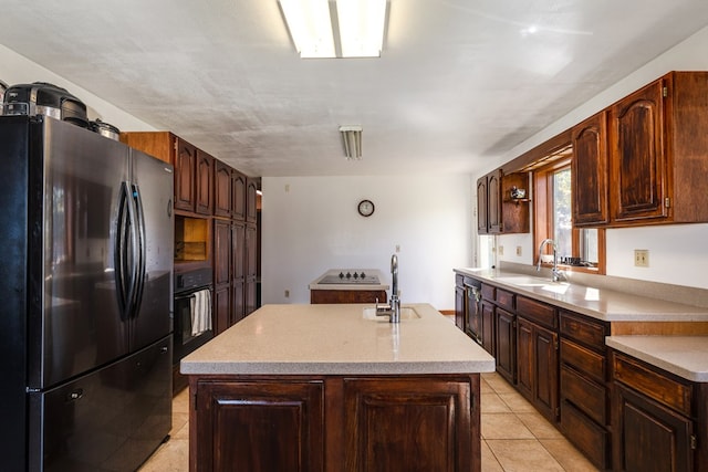 kitchen featuring refrigerator, a kitchen island, and sink