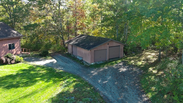 view of outbuilding featuring a garage and a lawn