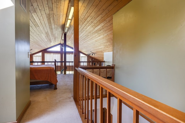 hall featuring wooden ceiling, carpet floors, and vaulted ceiling